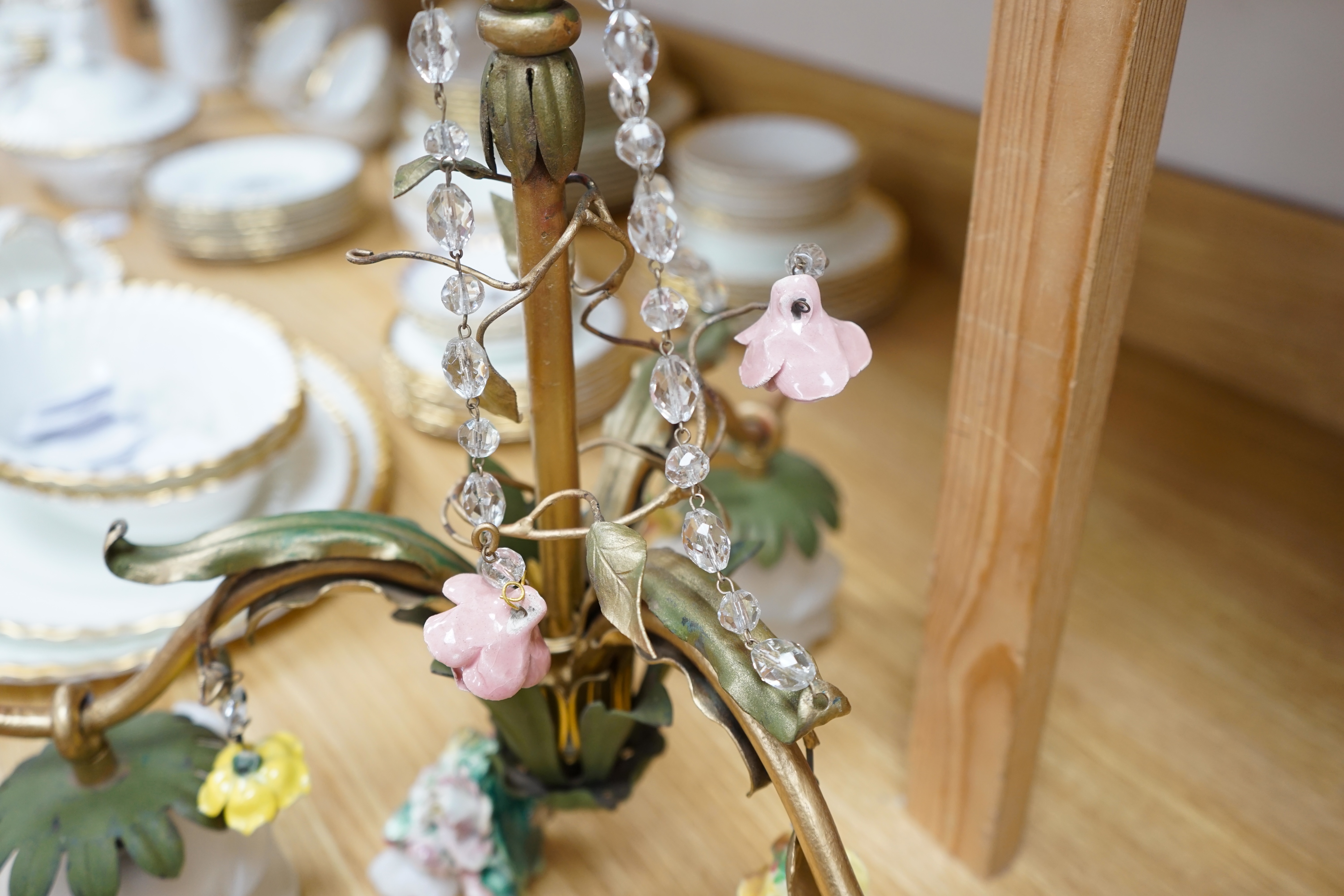 A French three arm coloured wrought iron ceiling light with frosted petal shades and porcelain flower decoration, circa 1930’s, 57cm high, 36cm across. Condition - fair